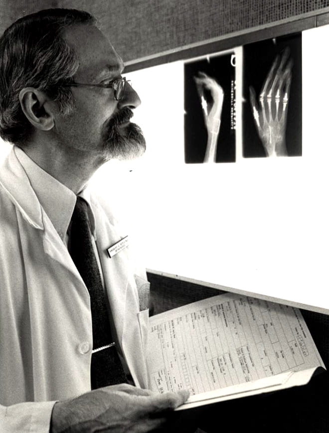 Kingsbury Heiple, MD examines x-rays