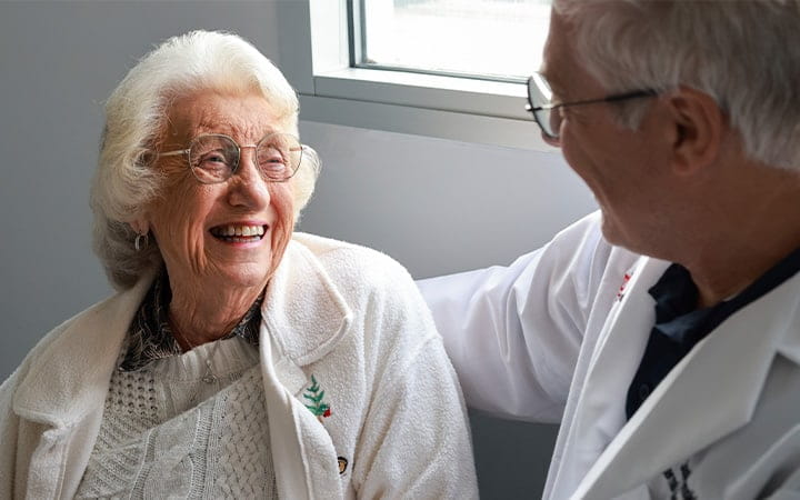 Helen Bishop smiles during a checkup with Edward Jastrzemski, MD