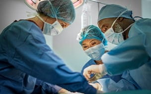 A team of doctors are performing surgery on a patient at hospital