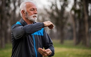 An active senior practices Tai Chi in a park