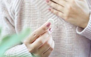 Woman holding a chewable antacid