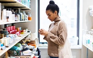 A young woman shopping for cosmetics in a zero waste store