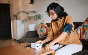 woman testing blood pressure