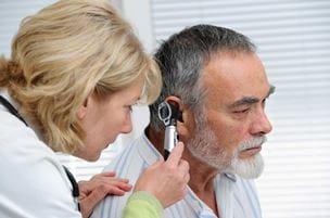 Older man getting ear examination