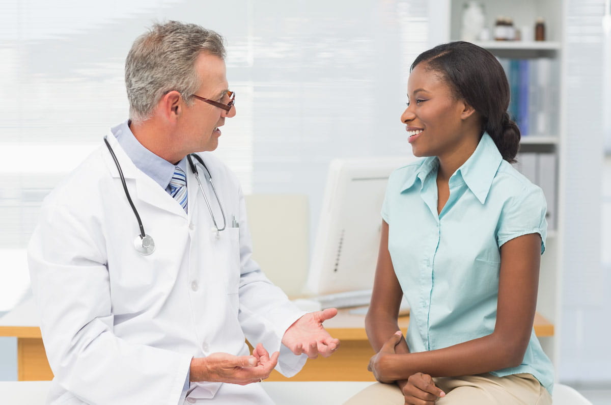 doctor talking with female patient