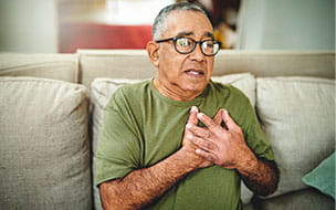Shot of a senior man holding his chest in pain