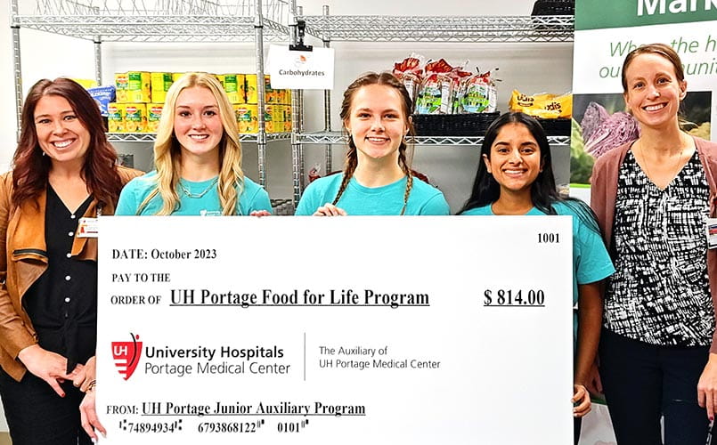 Members of the UH Portage Junior Auxiliary presenting a check to the Food for Life program