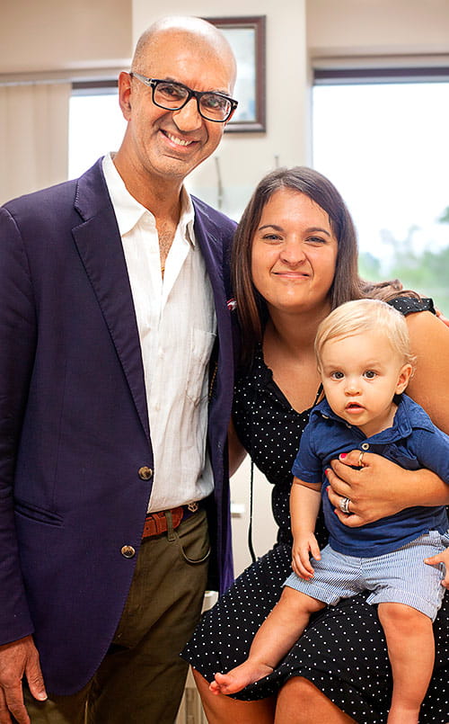 Samir Ahuja, MD poses with Christina and her son