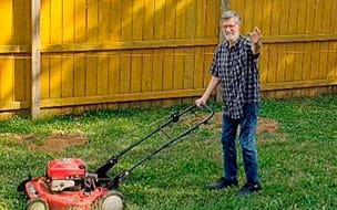Daniel Boynton mows the lawn