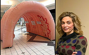 Elizabeth Brandewie, MD stands aside a picture of UH's giant inflatable colon