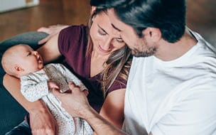 Man and woman hold newborn