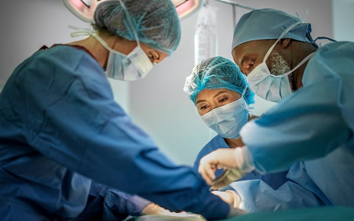 A team of doctors are performing surgery on a patient at hospital