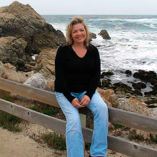 A smiling Linda Estrada at the beach