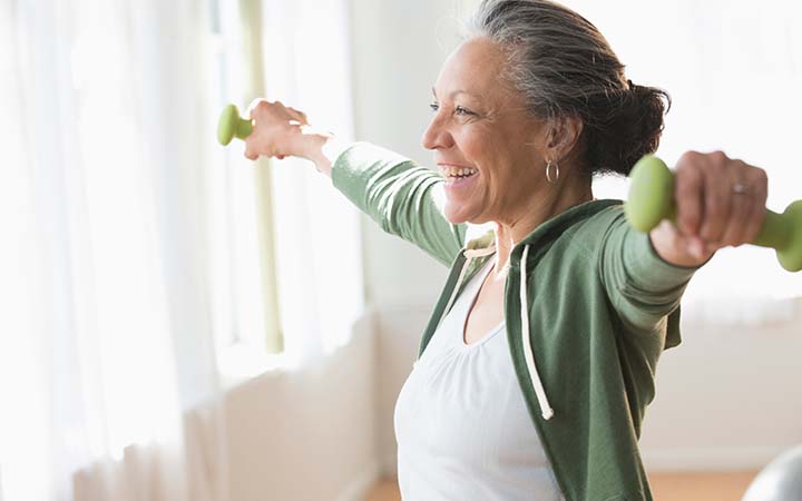 older woman working out with light weights