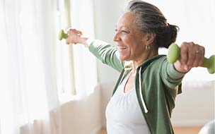 older woman working out with light weights