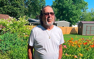 Rocco Greco stands outdoors on a sunny day