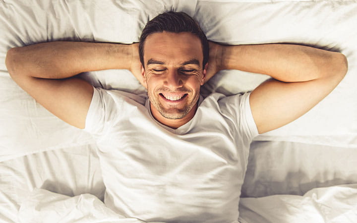 Smiling man in bed