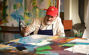 Mark Krieger painting a mural
