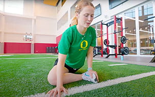 Jenna Lilley exercises on the indoor field at UH Drusinsky Sports Medicine Institute at UH Ahuja Medical Center