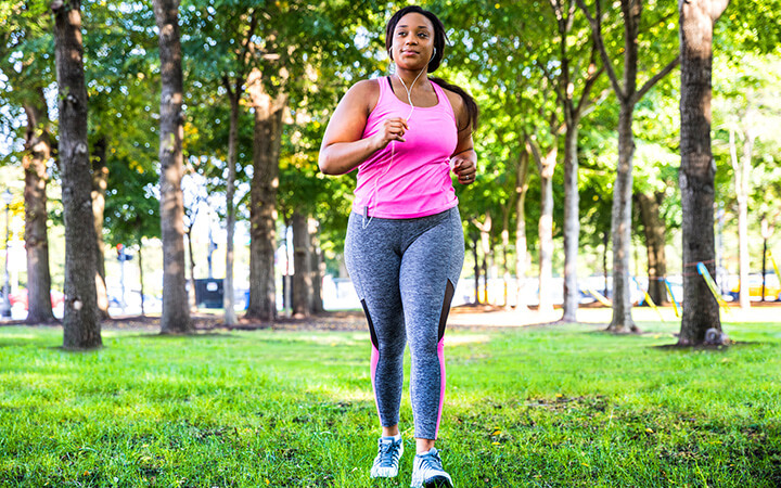 A woman jogging and exercising at the park 