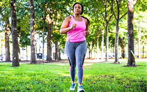 A woman jogging and exercising at the park