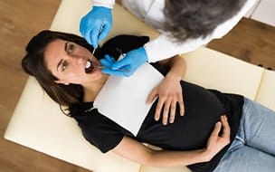 A pregnant woman at her regular dental checkup