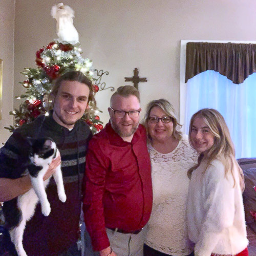Jason and family around the Christmas tree