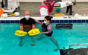 Joe Sadie performing exercises in the pool as part of aquatic therapy