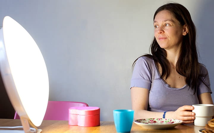 Woman looking at an artificial light source