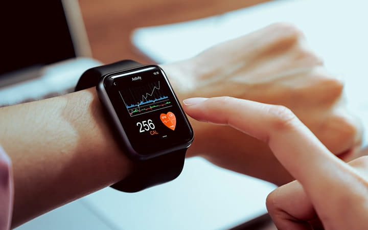 Close up of hand touching smartwatch with health app on the screen