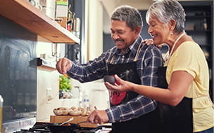 older man and woman preparing food