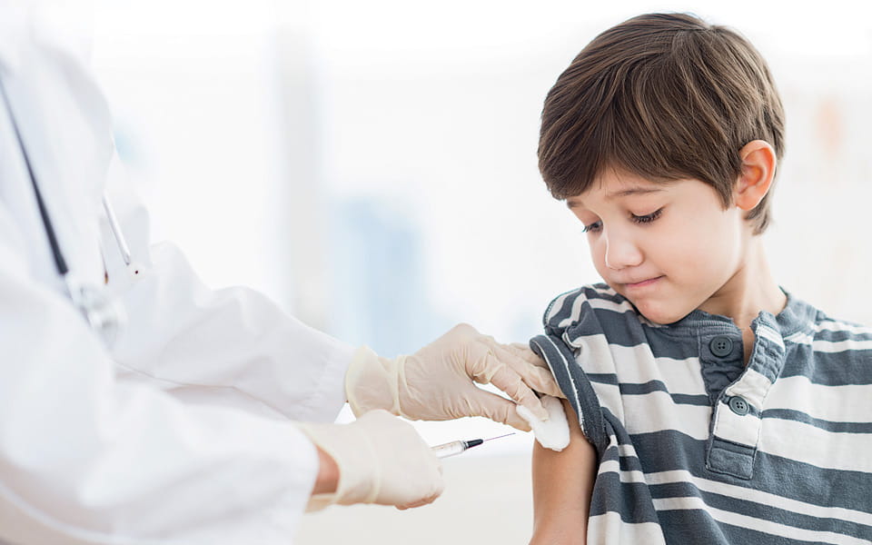 Boy getting a shot at doctor's office