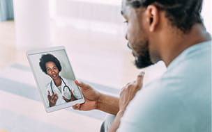 A patient talking to a doctor using digital tablet