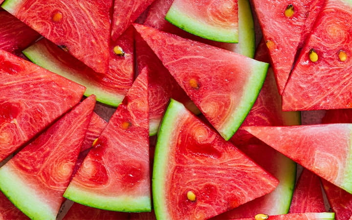 Red watermelon sliced into triangular pieces