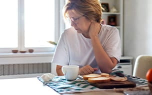 Older woman looking away from her breakfast
