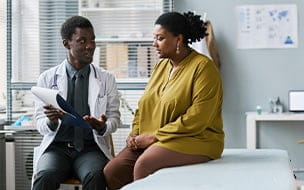 A woman talking to her doctor in a medical clinic