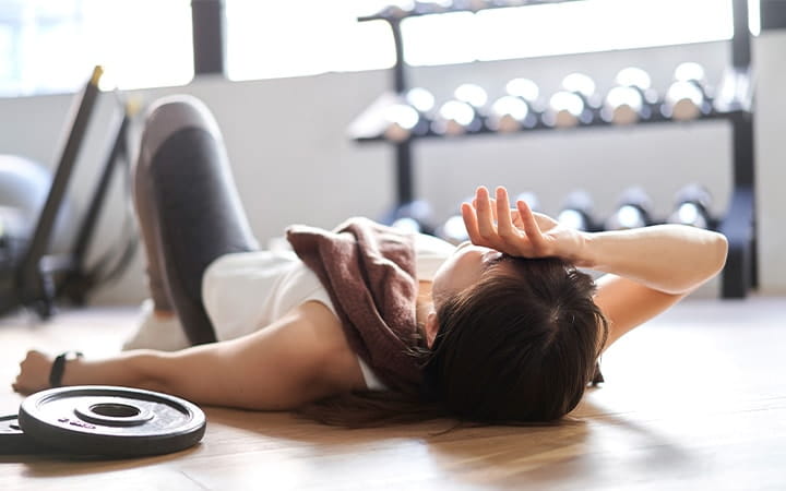 An Asian woman lying down in the training gym