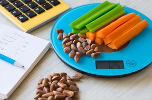 Vegetables and nuts atop a digital scale