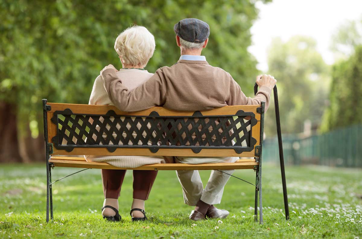 An older couple on a park bench