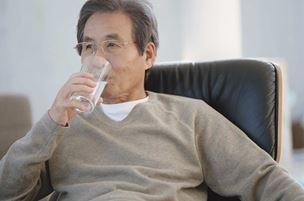 Middle-aged man drinking a glass of water