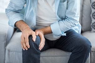 Man clutching knee
