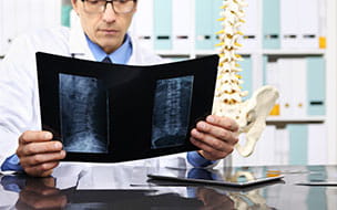 doctor lookiing at spine x-rays