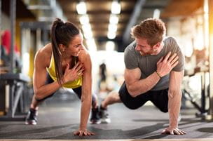 Woman and man doing one-armed push-ups