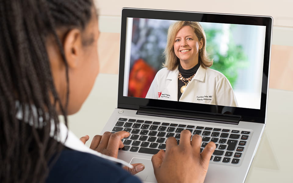 Woman using UH Virtual Visit on her laptop