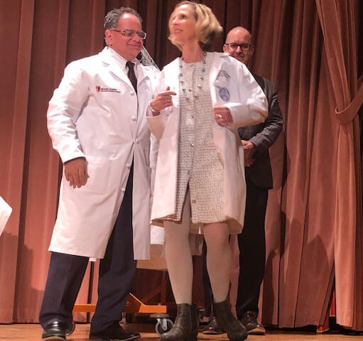 2022 Distinguished Physician coating ceremony, Drs. Megerian Miller presenting Dr. with white coat