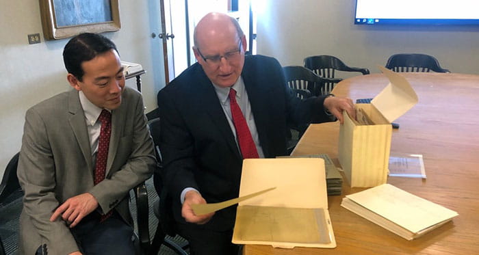 John Herzenberg and Raymond Liu looking at records