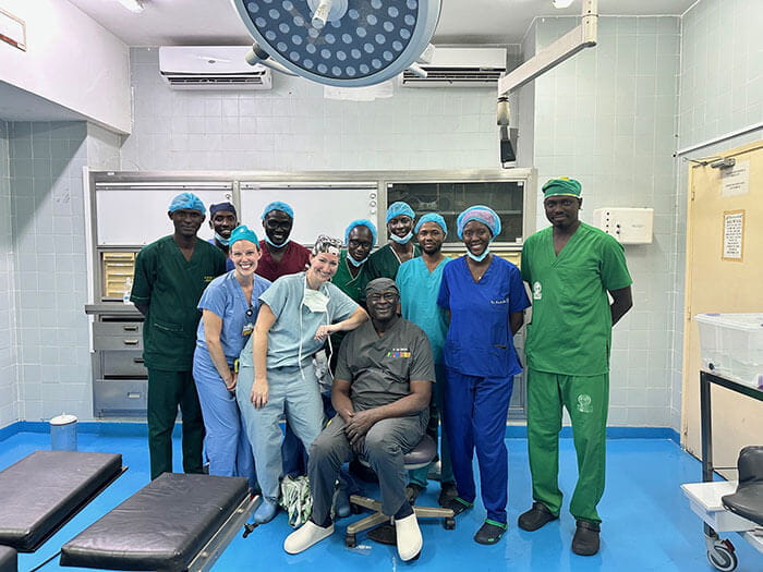 Drs. Pope & Samarco pose with their clinician-hosts and OR team in Senegal.