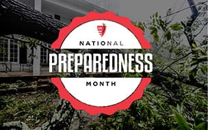 Fallen tree in front yard after a storm with National Preparedness Month emblem