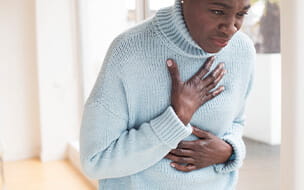 Mature woman touching chest in pain