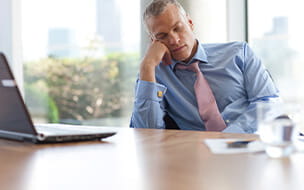 Businessman napping at desk in office